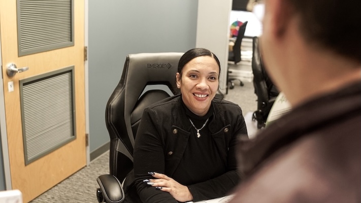 Receptionist at Dental Care of Burlington talking to a patient.