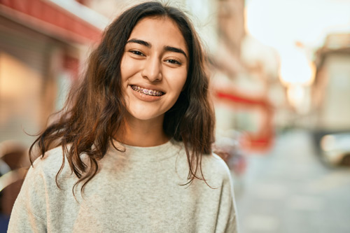 Image of a teenage girl smiling, at Dental Care of Burlington.