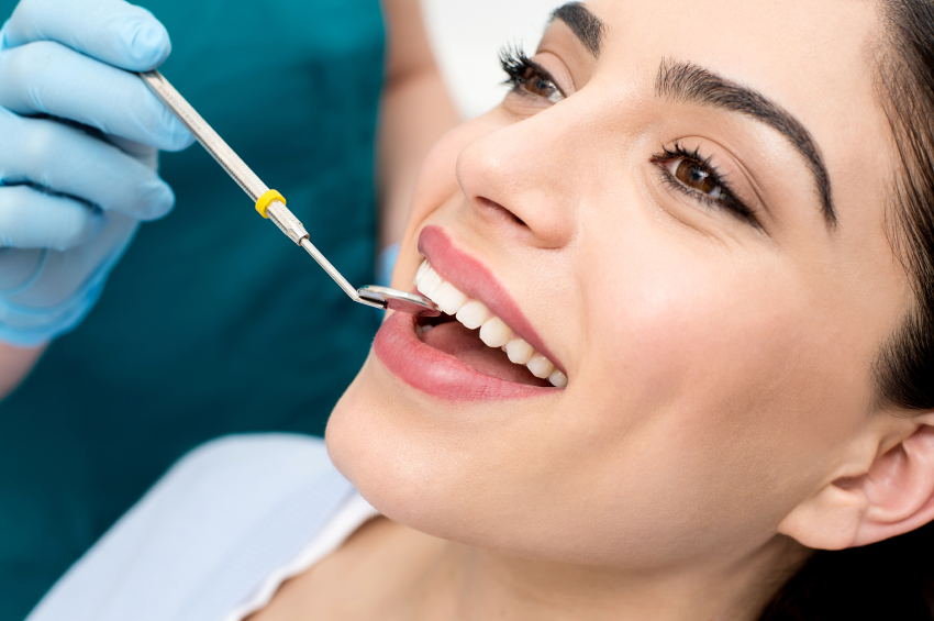 Woman with nice teeth in dental chair at Dental Care of Burlington in Burlington, MA